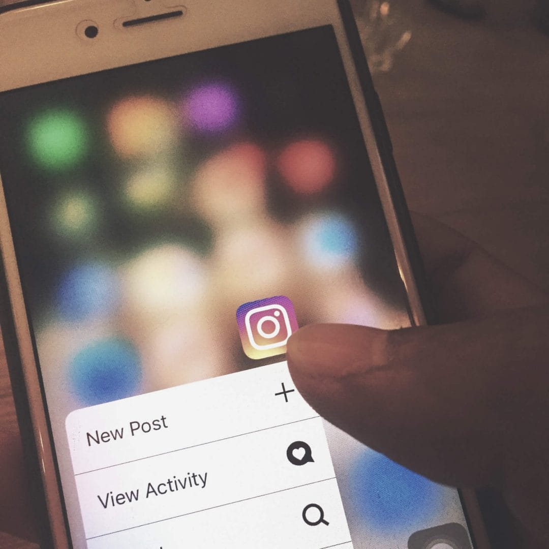 small business instagram tips: Close up to mobile phone with instagram logo with the option of "new post"