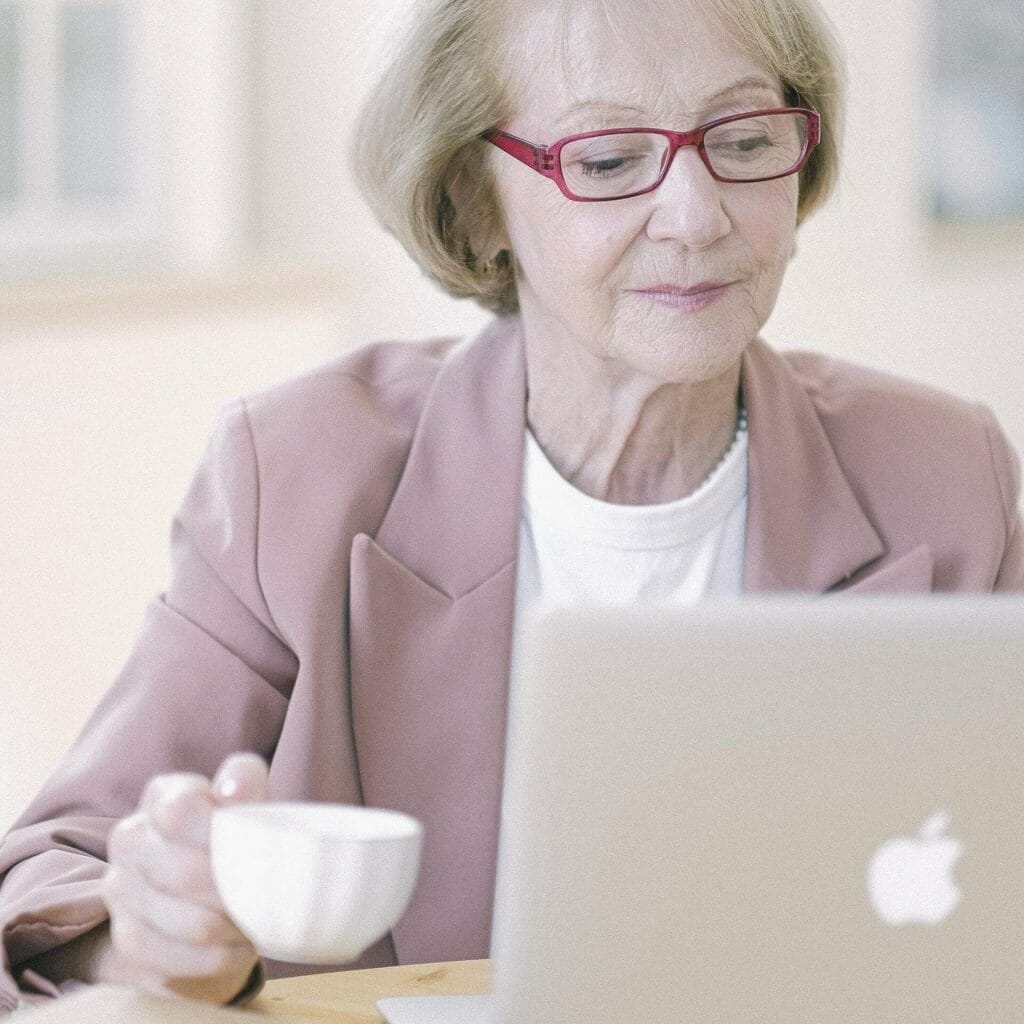 Woman on her laptop searching the internet because she's not sure where to find free images